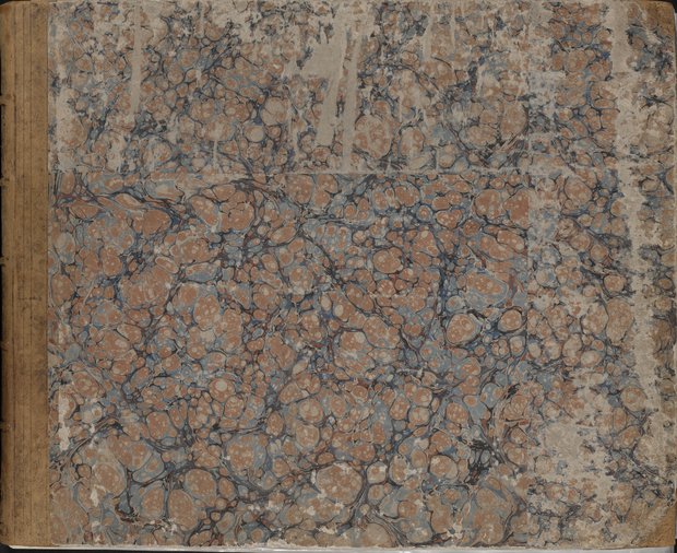 Visible reflectance photograph Front cover with blue and red patterned stone marble paper and covered with brown leather at the corners and the spine
